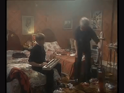 Two men at a piano, late at night, surrounded by crumpled paper, still trying